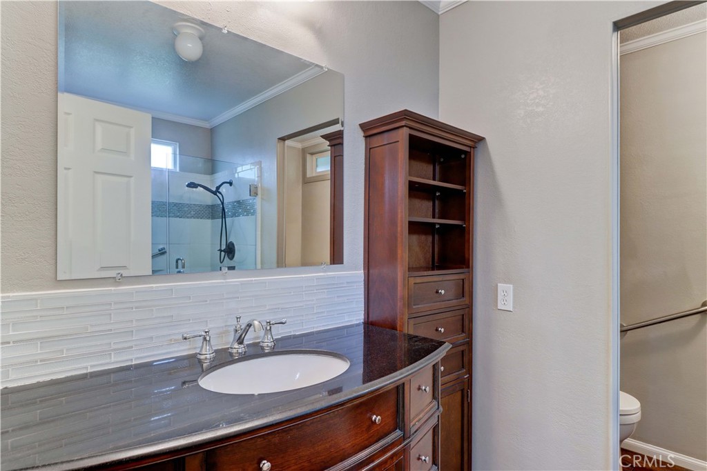 2509 View Lake Santa Ana, CA 92705 - Photo 32 of 74 a bathroom with a granite countertop sink and a mirror
