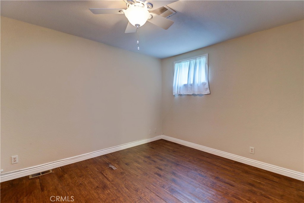 2509 View Lake Santa Ana, CA 92705 - Photo 37 of 74 a view of an empty room with wooden floor and a window