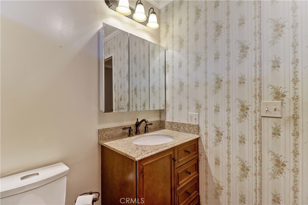 2509 View Lake Santa Ana, CA 92705 - Photo 40 of 74 a bathroom with a sink a toilet and a mirror
