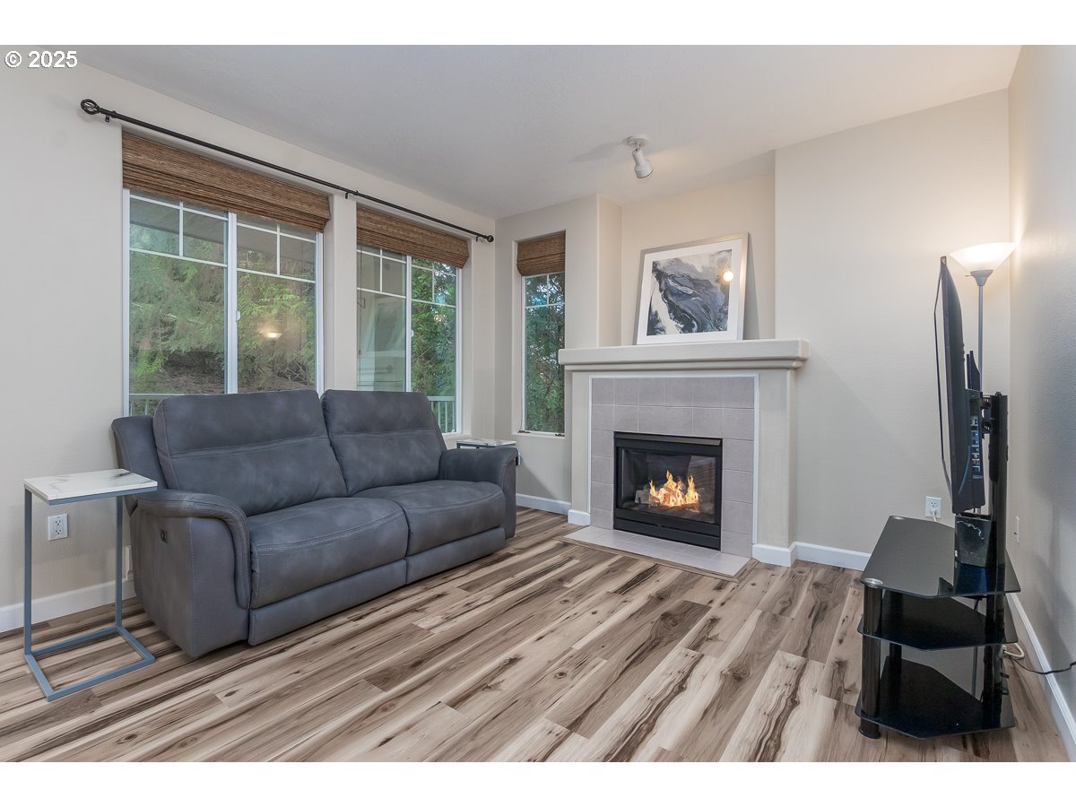 14575 Southwest Magpie Lane, Unit 102 Beaverton, OR 97007 - Photo 12 of 30 a living room with furniture and a fireplace