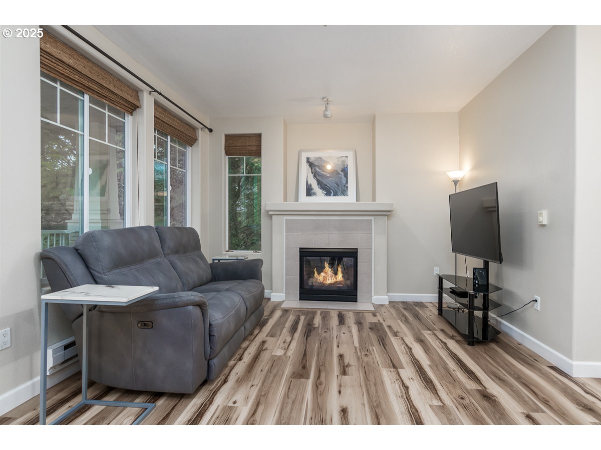 14575 Southwest Magpie Lane, Unit 102 Beaverton, OR 97007 - Photo 13 of 30 a living room with furniture and a fireplace