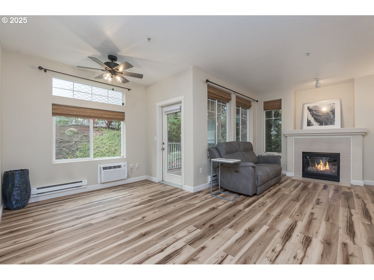 14575 Southwest Magpie Lane, Unit 102 Beaverton, OR 97007 - Photo 14 of 30 a living room with furniture and a fireplace