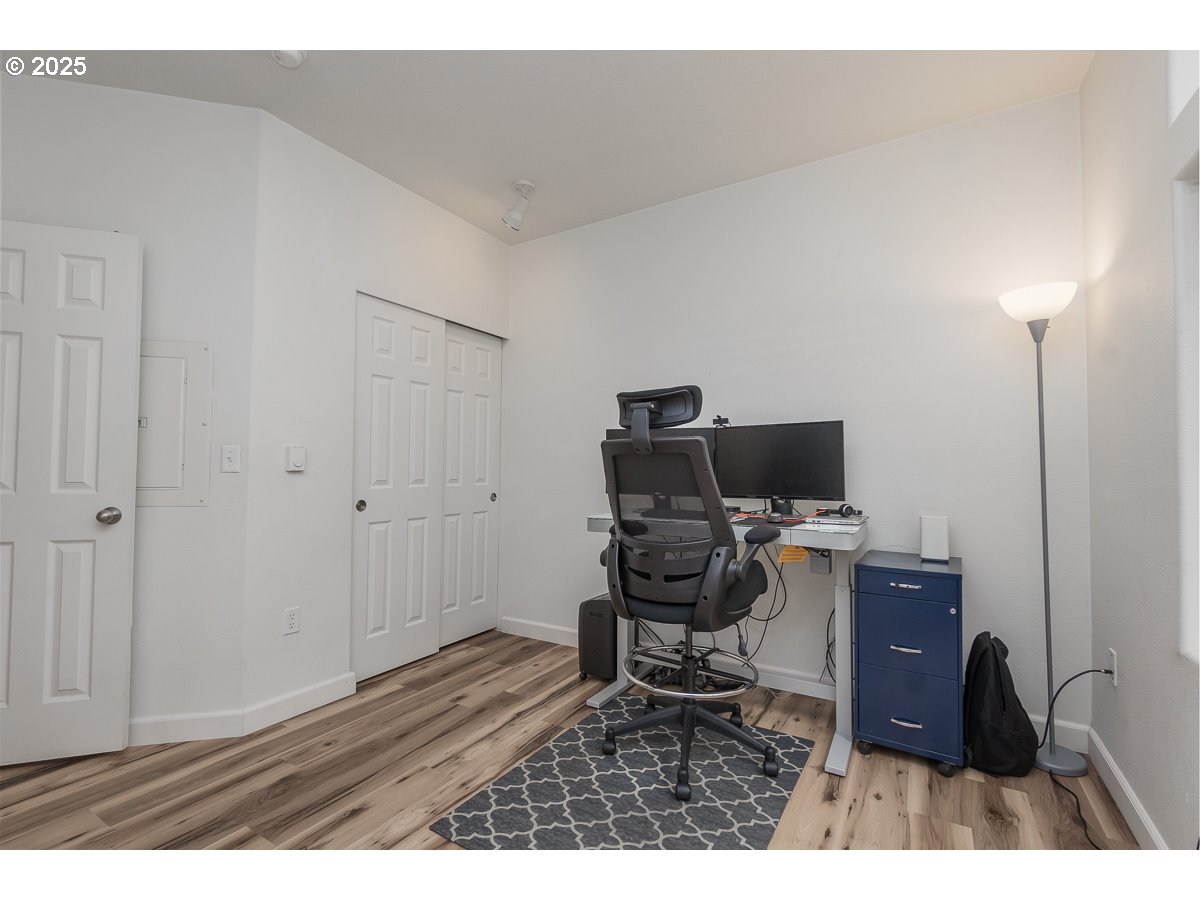 14575 Southwest Magpie Lane, Unit 102 Beaverton, OR 97007 - Photo 19 of 30 a workspace with furniture and wooden floor
