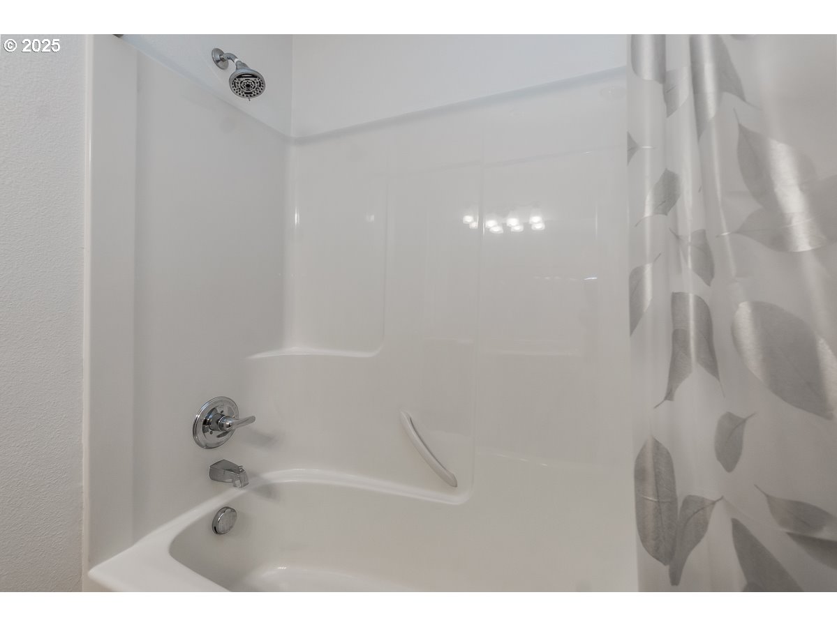 14575 Southwest Magpie Lane, Unit 102 Beaverton, OR 97007 - Photo 21 of 30 a bathroom with a bathtub