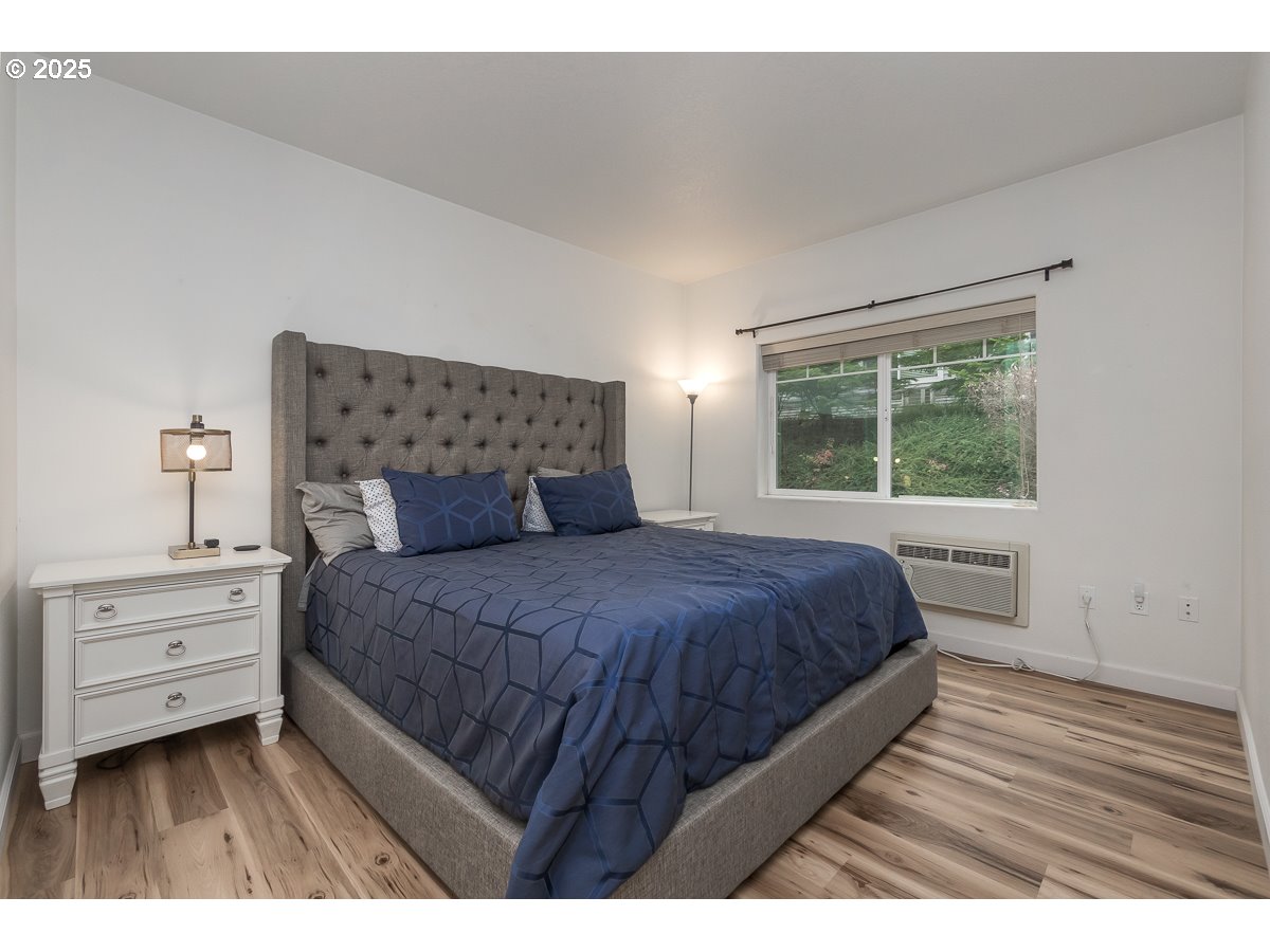 14575 Southwest Magpie Lane, Unit 102 Beaverton, OR 97007 - Photo 23 of 30 a bedroom with a bed and a window