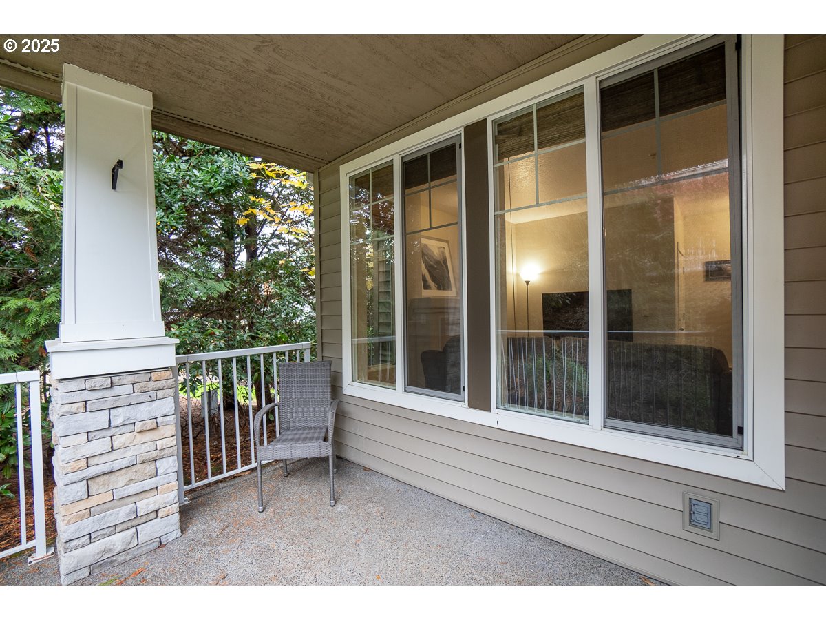14575 Southwest Magpie Lane, Unit 102 Beaverton, OR 97007 - Photo 28 of 30 a view of a porch with a table and chairs