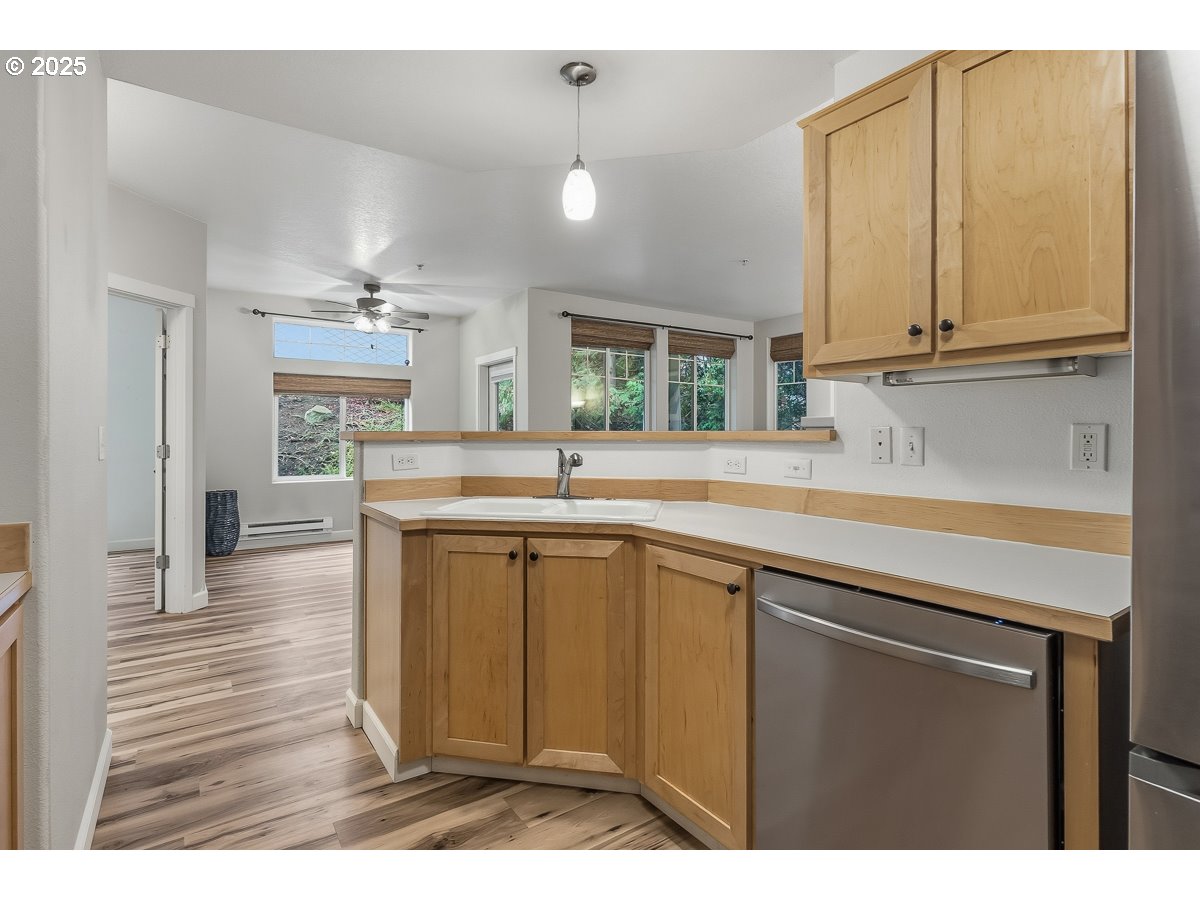 14575 Southwest Magpie Lane, Unit 102 Beaverton, OR 97007 - Photo 10 of 30 a kitchen with cabinets and window