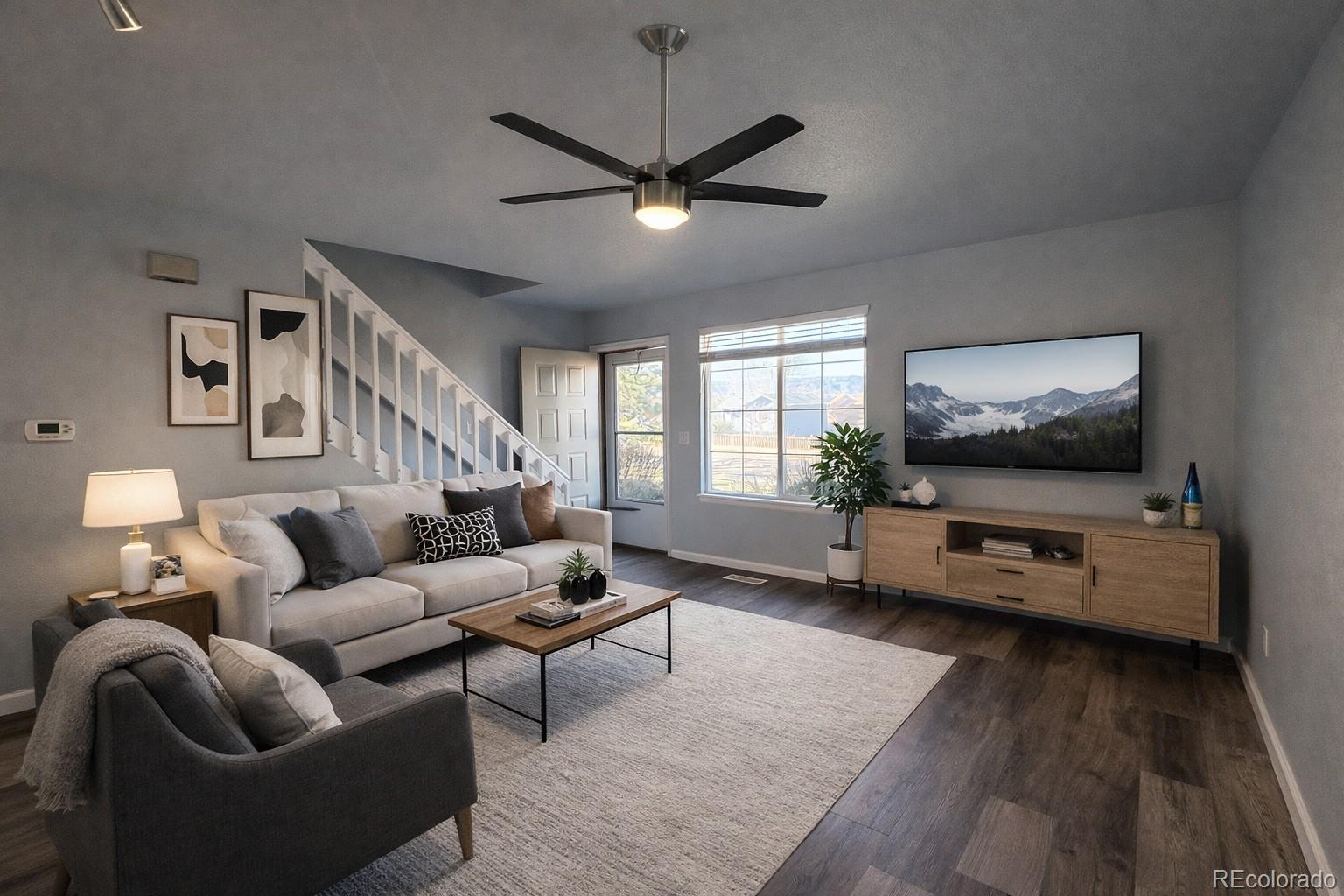 805 Summer Drive Highlands Ranch, CO 80126 - Photo 2 of 10 a living room with furniture and a flat screen tv