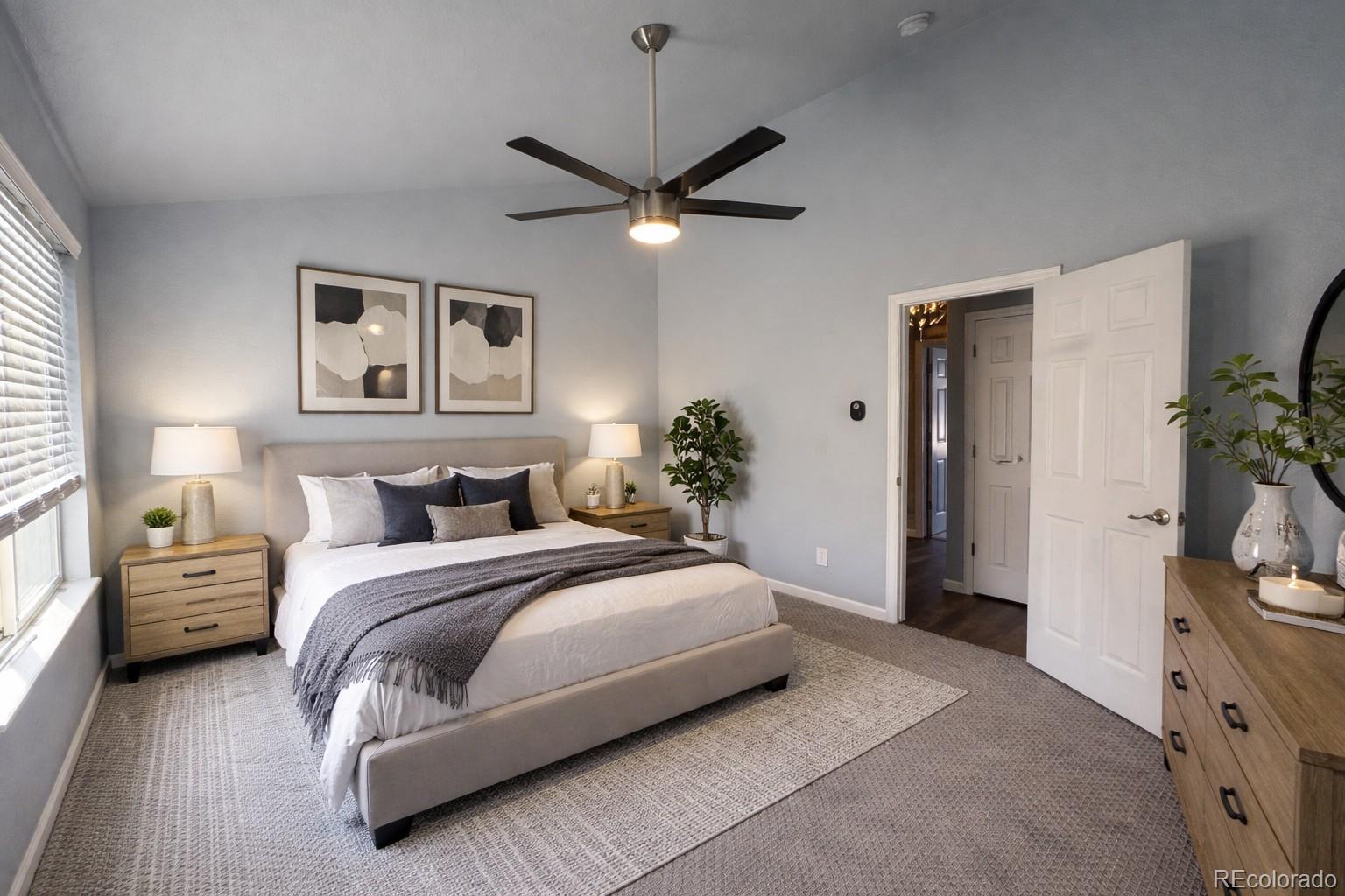 805 Summer Drive Highlands Ranch, CO 80126 - Photo 5 of 10 a bedroom with a bed and a chandelier