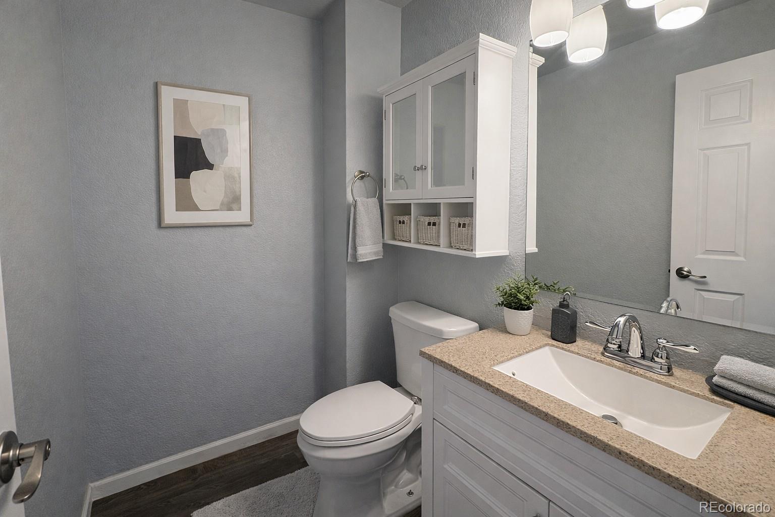 805 Summer Drive Highlands Ranch, CO 80126 - Photo 6 of 10 a bathroom with a granite countertop toilet sink and mirror