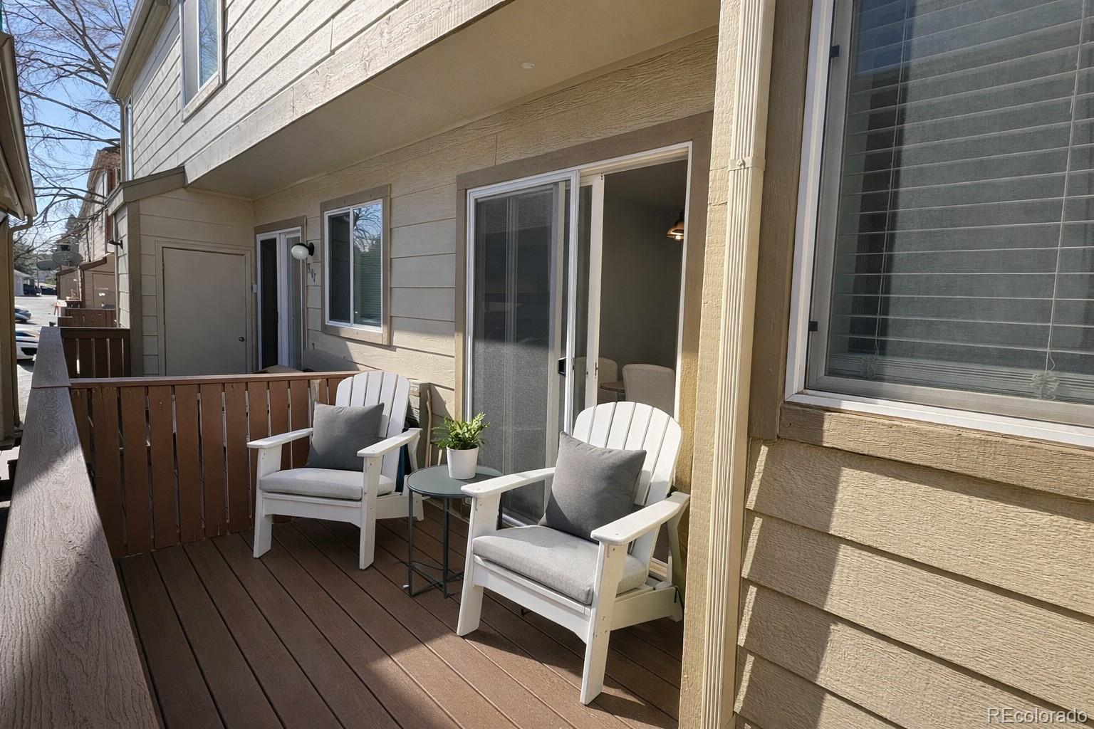 805 Summer Drive Highlands Ranch, CO 80126 - Photo 9 of 10 a balcony with couch and wooden floor