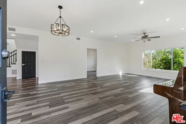 a view of an entryway with wooden floor