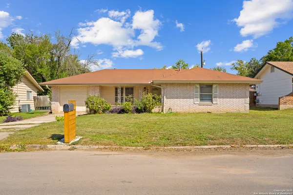 a front view of a house with a garden and yard
