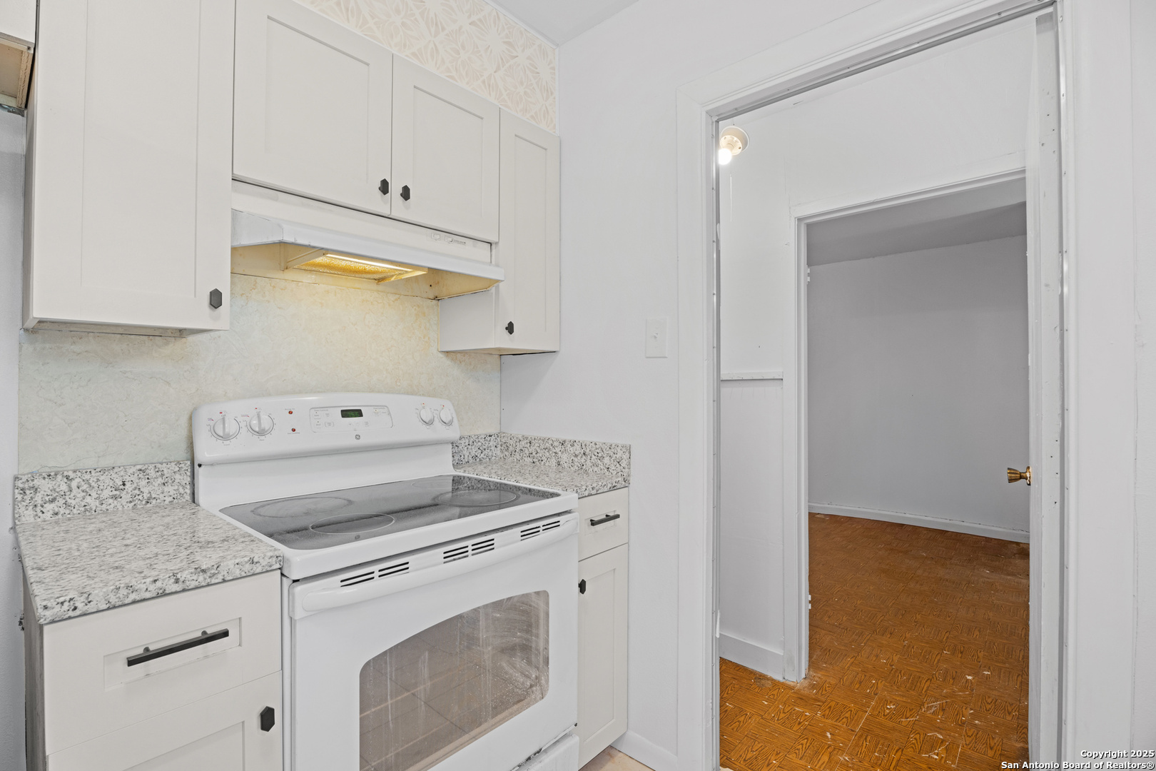 4427 First View Drive San Antonio, TX 78217 - Photo 13 of 26 a kitchen with white cabinets and white appliances