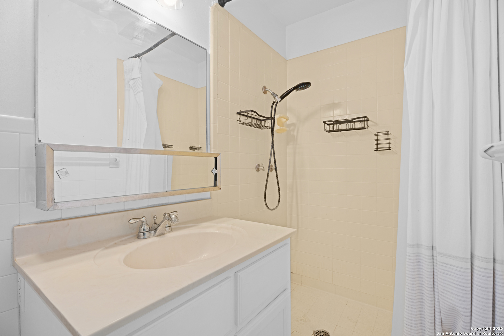 4427 First View Drive San Antonio, TX 78217 - Photo 18 of 26 a bathroom with a sink and a mirror