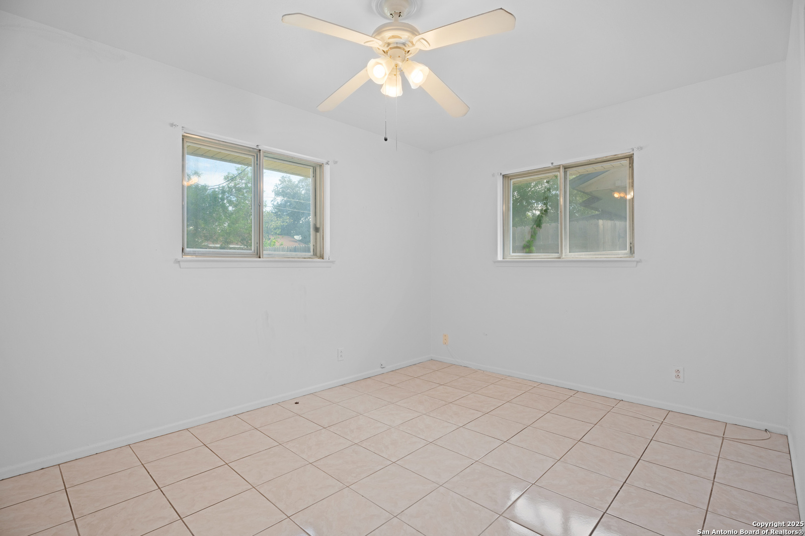 4427 First View Drive San Antonio, TX 78217 - Photo 19 of 26 an empty room with a chandelier fan and windows