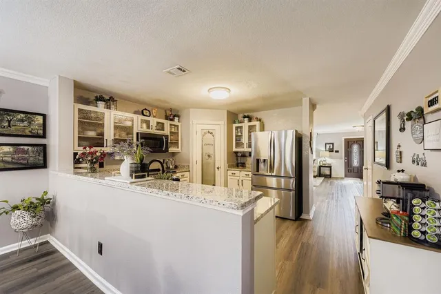 a kitchen with a refrigerator and a counter top space