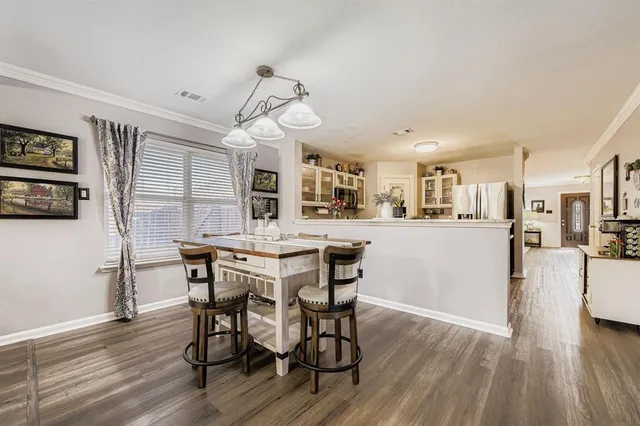 a view of a dining room with furniture and wooden floor