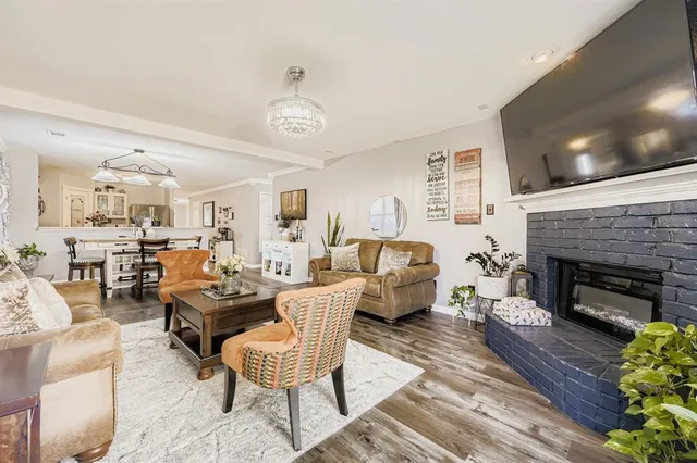 a living room with furniture fireplace and flat screen tv