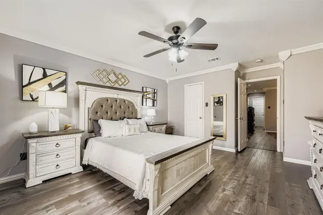 a bedroom with a large bed and a chandelier