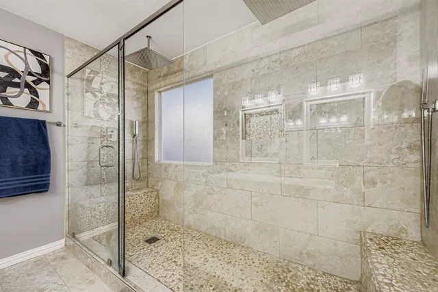 a bathroom with a glass door shower