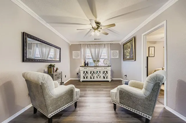 a living room with furniture a lamp and a chandelier