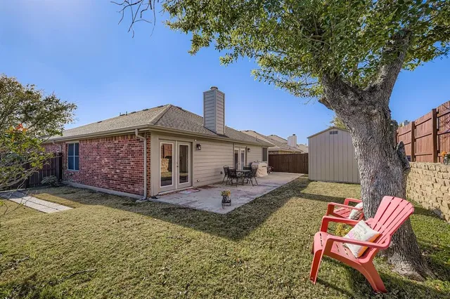 a front view of a house with a yard patio and fire pit