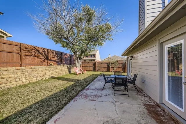 a view of a backyard with sitting area