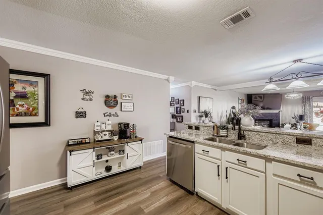 a kitchen with stainless steel appliances a sink stove and refrigerator