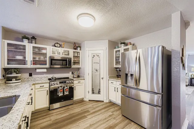 a kitchen with stainless steel appliances a refrigerator stove and sink