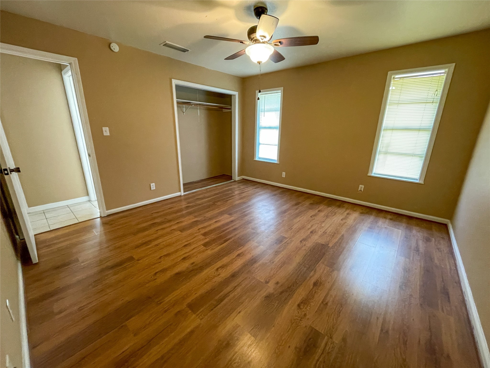 401 Anderson Road Cuero, TX 77954 - Photo 17 of 25 an empty room with wooden floor and windows