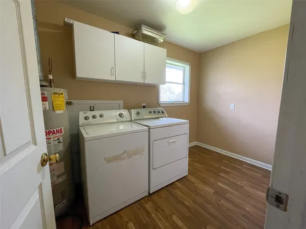 a view of a kitchen with a sink and a refrigerator