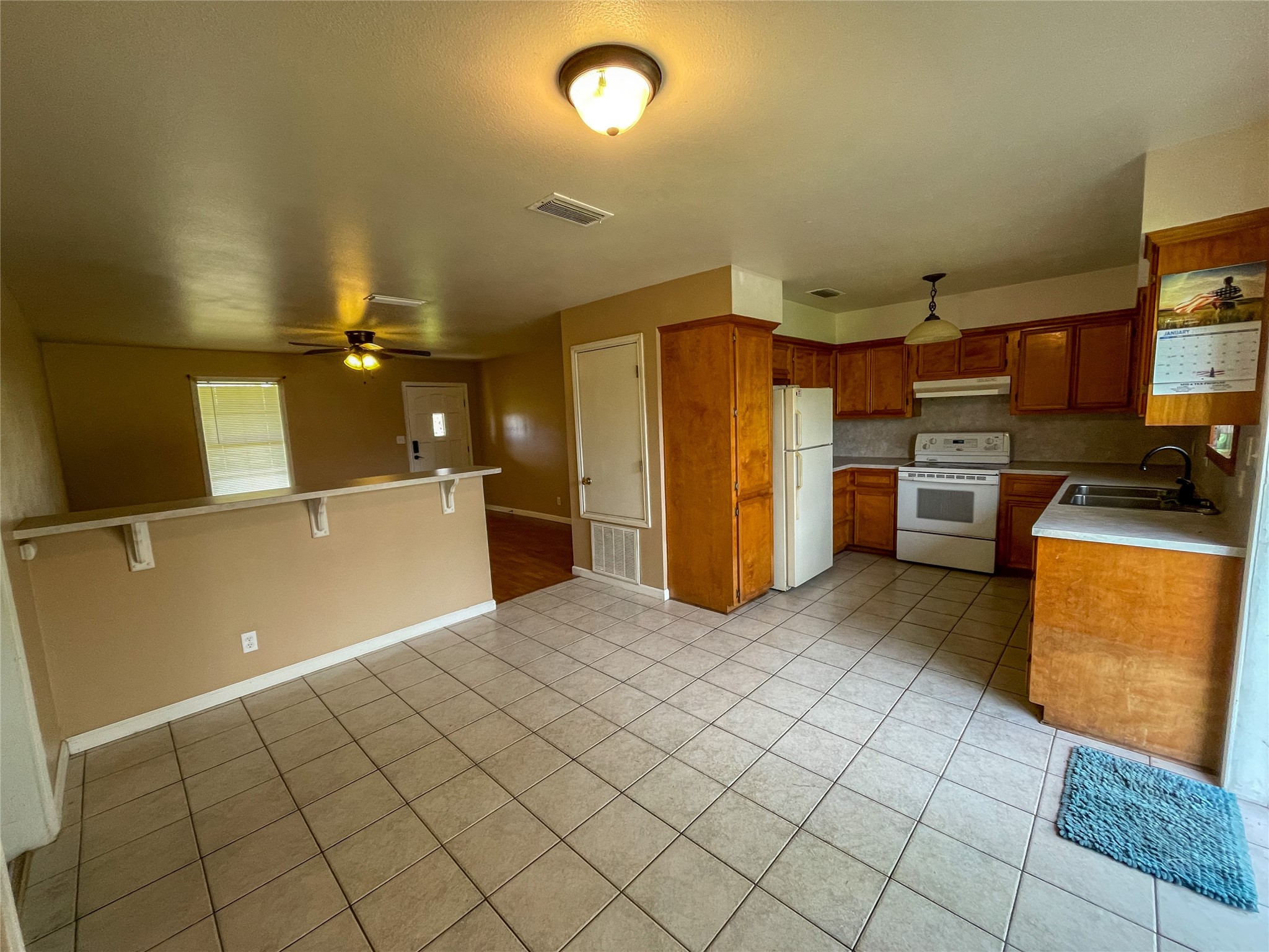 401 Anderson Road Cuero, TX 77954 - Photo 8 of 25 a kitchen with refrigerator and cabinets