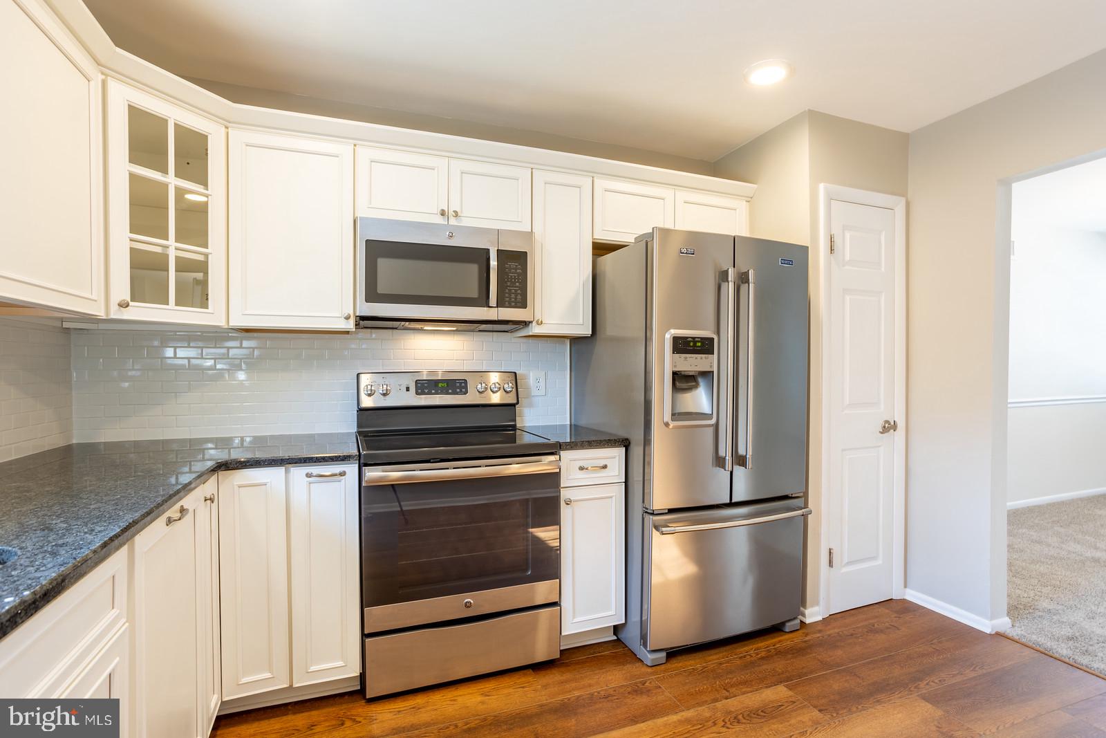 143 Midland Road Glen Burnie, MD 21060 - Photo 12 of 44 a kitchen with stainless steel appliances a refrigerator microwave and sink
