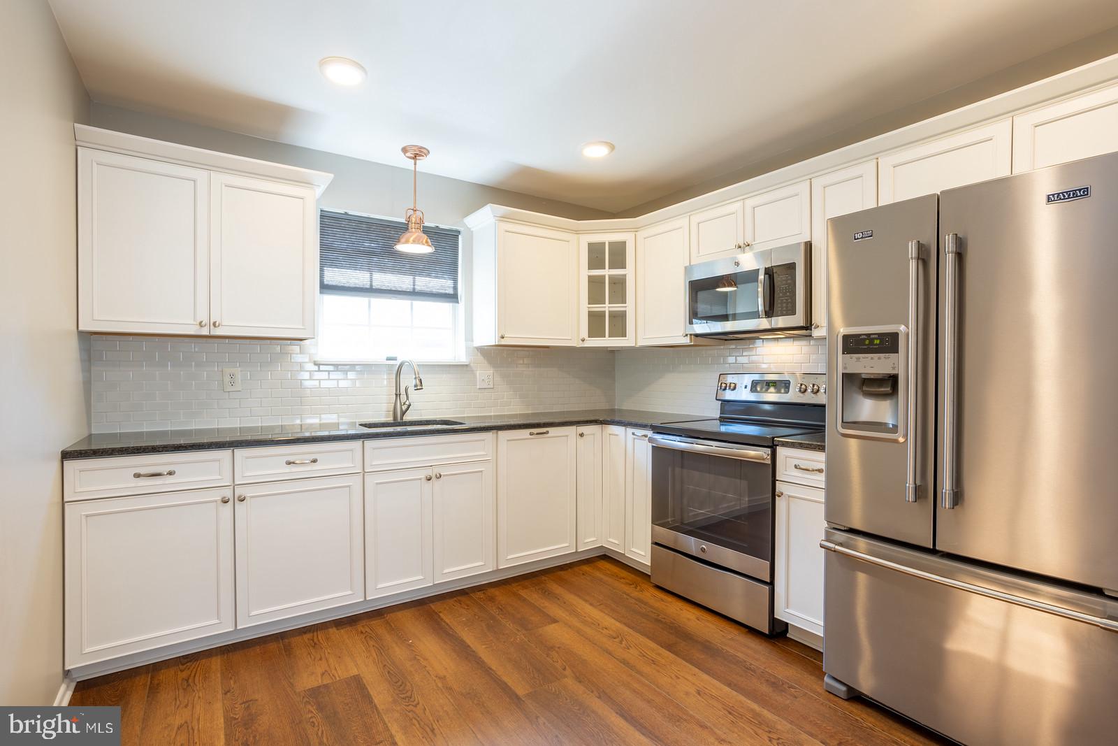 143 Midland Road Glen Burnie, MD 21060 - Photo 13 of 44 a kitchen with stainless steel appliances granite countertop a refrigerator sink and microwave