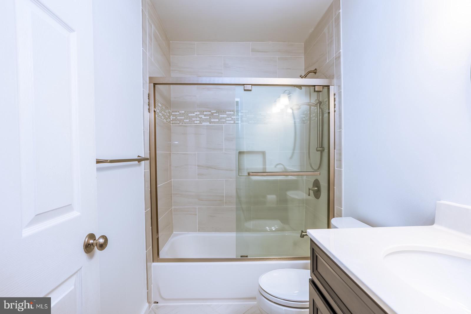 143 Midland Road Glen Burnie, MD 21060 - Photo 15 of 44 a bathroom with a sink a toilet and shower