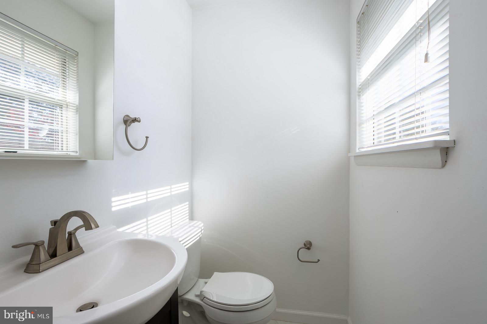 143 Midland Road Glen Burnie, MD 21060 - Photo 20 of 44 a bathroom with a toilet sink and mirror
