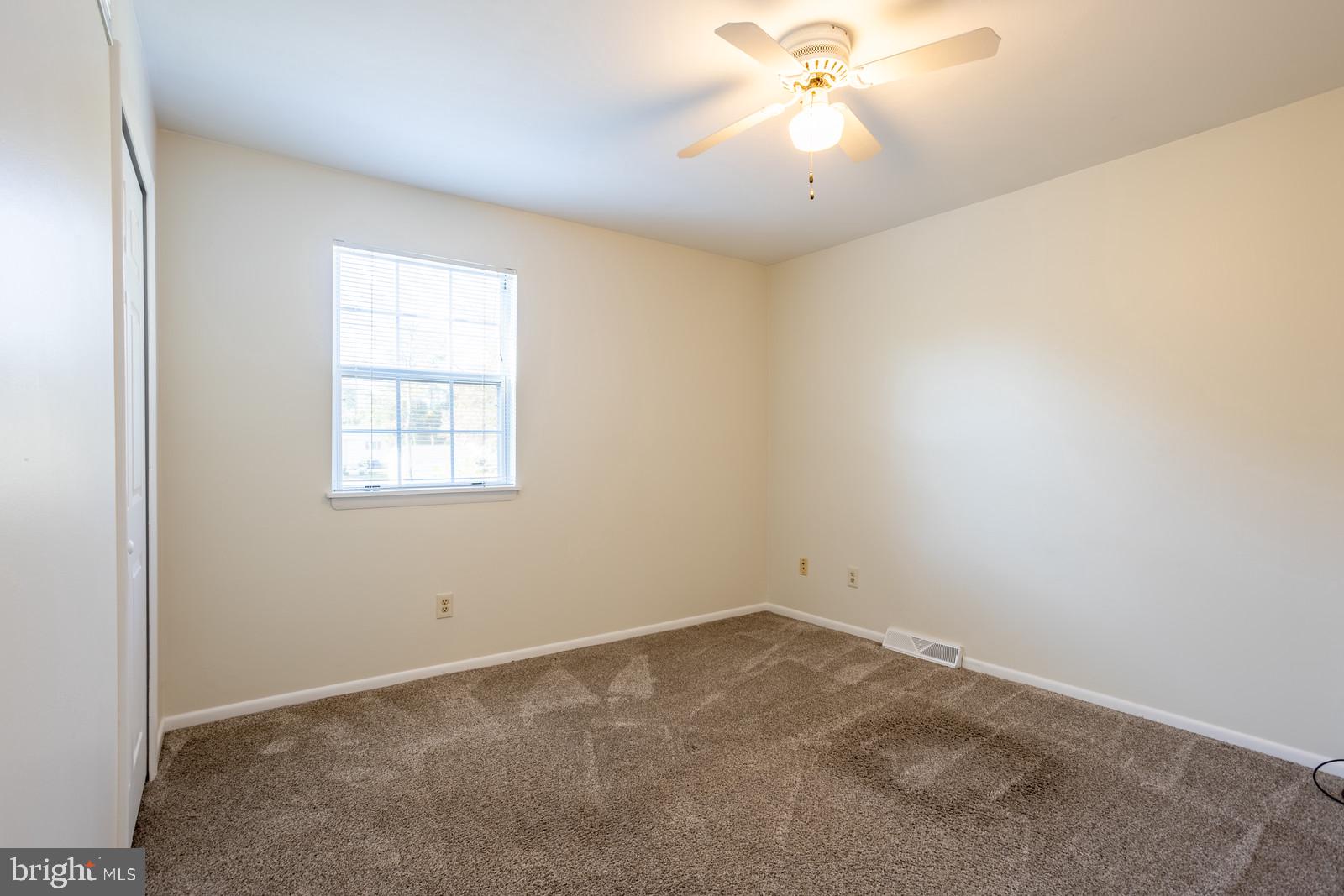 143 Midland Road Glen Burnie, MD 21060 - Photo 23 of 44 an empty room with a window and a fan