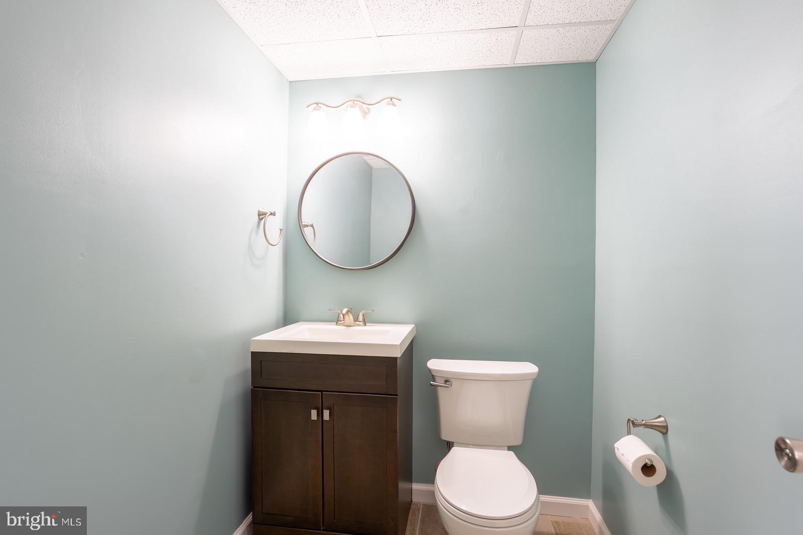 143 Midland Road Glen Burnie, MD 21060 - Photo 32 of 44 a bathroom with a toilet a sink and mirror