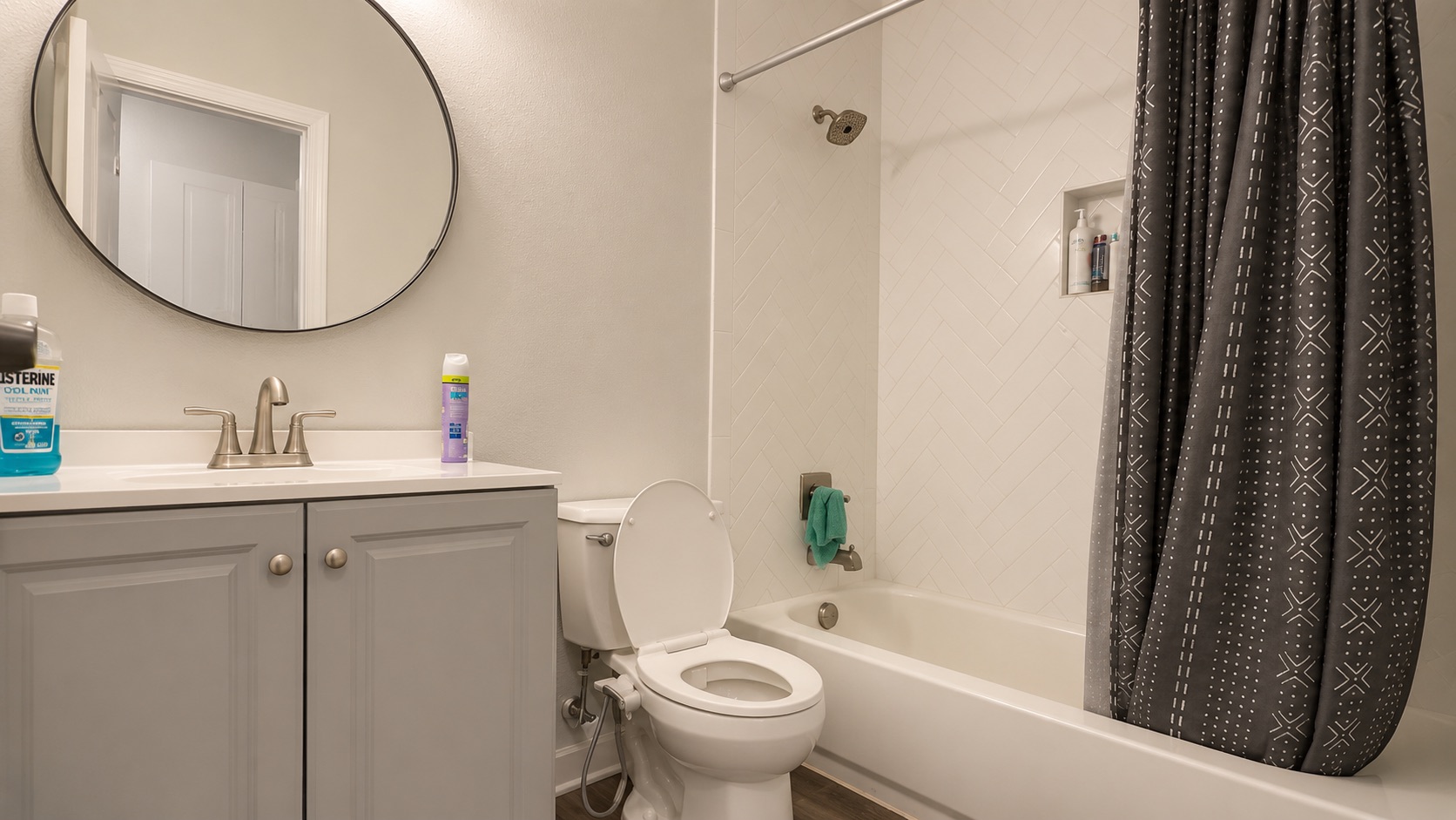 6016 Signal Point Austin, TX 78724 - Photo 14 of 20 A well-appointed bath features a sleek vanity, toilet, and a tiled shower-tub combo.