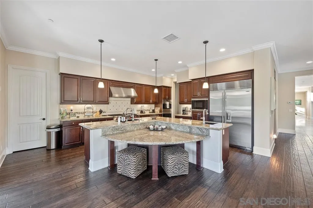 14480 Cheyenne Trail Poway, CA 92064 - Photo 16 of 23 a kitchen with stainless steel appliances granite countertop a sink a stove and a refrigerator