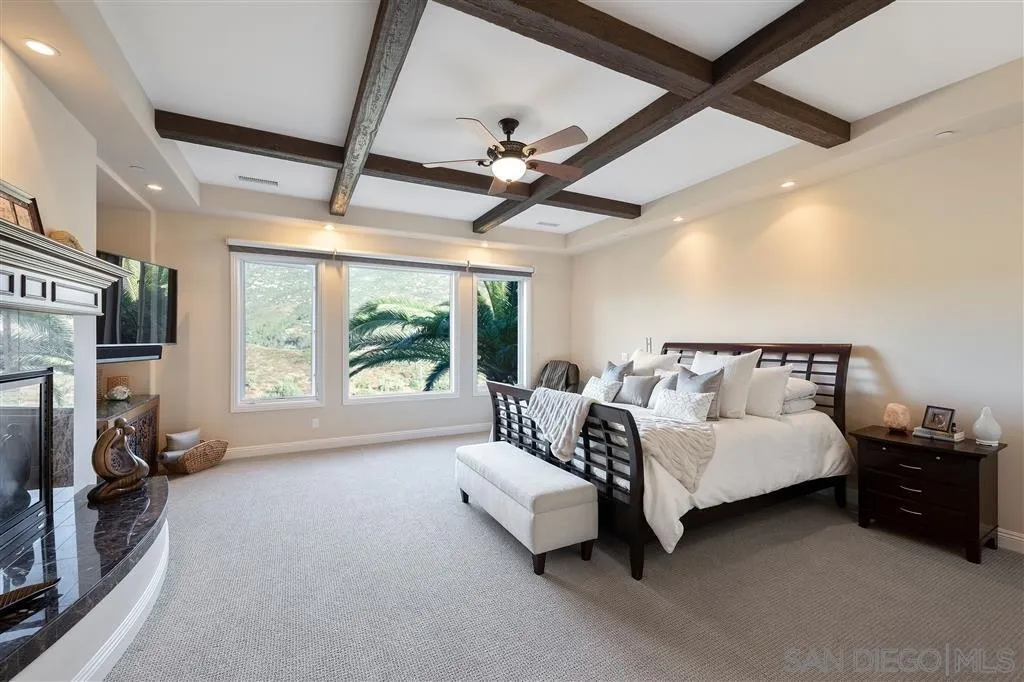 14480 Cheyenne Trail Poway, CA 92064 - Photo 17 of 23 a spacious bedroom with a bed and a large window