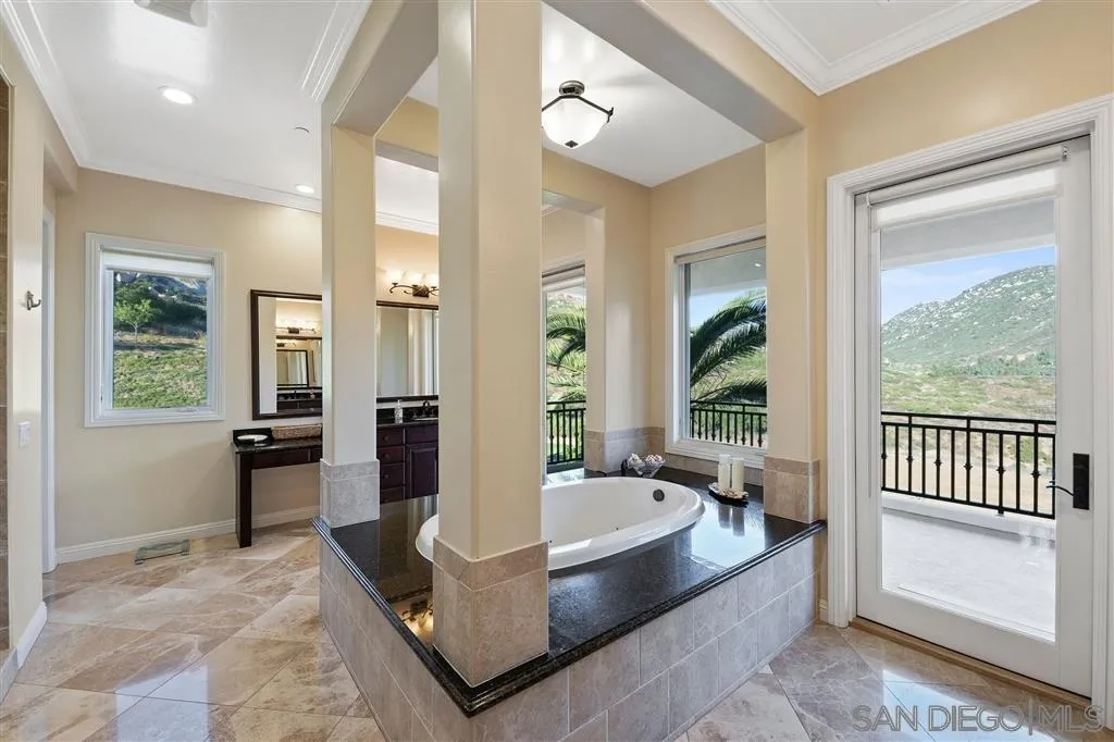 14480 Cheyenne Trail Poway, CA 92064 - Photo 18 of 23 a spacious bathroom with a tub shower and windows