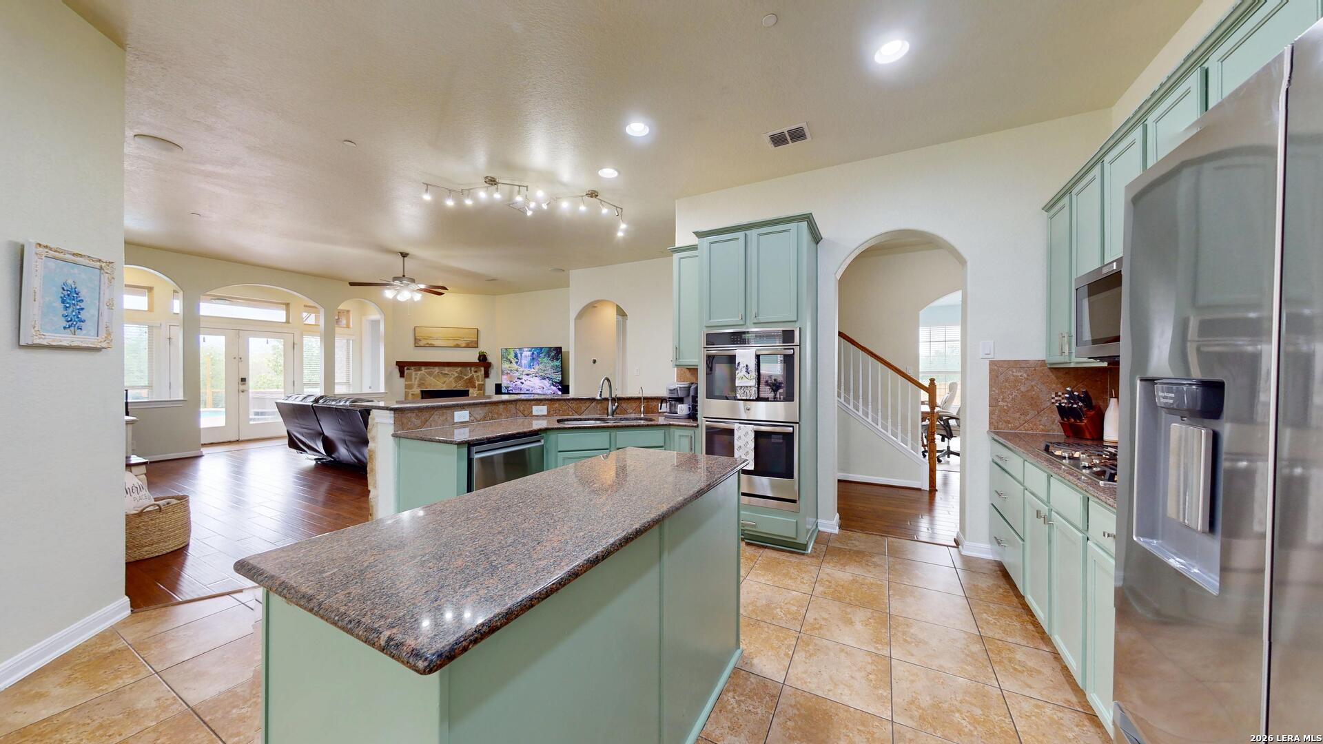 10111 Shallow Bank Converse, TX 78109 - Photo 19 of 65 a kitchen with stainless steel appliances granite countertop lots of counter top space