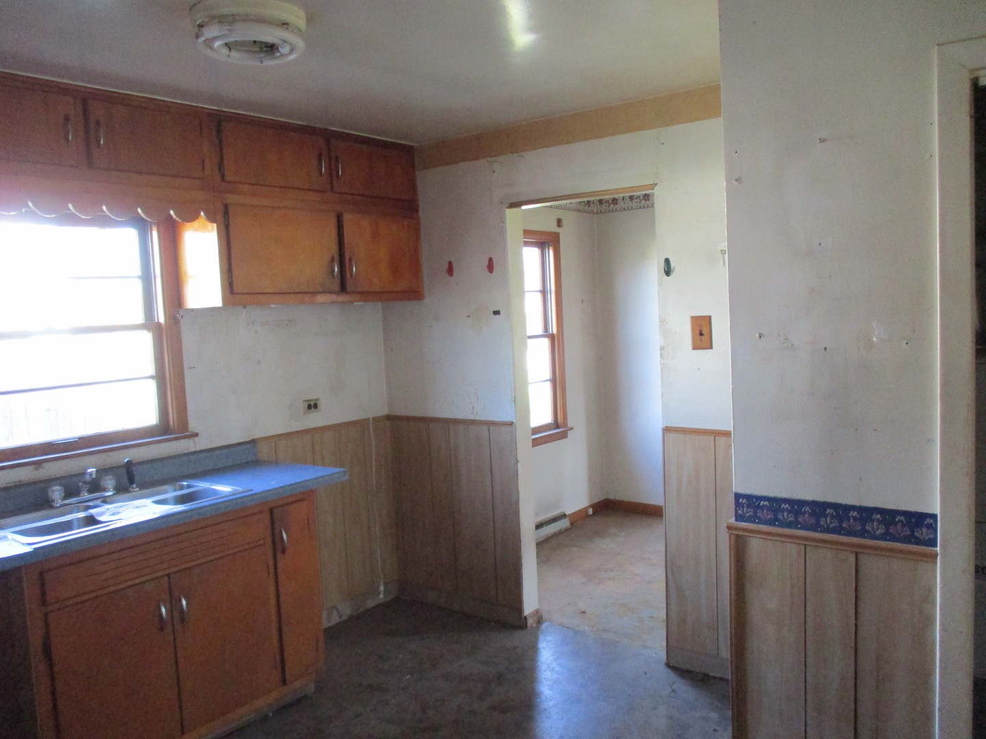2810 186th Street Lansing, IL 60438 - Photo 13 of 14 a kitchen with sink cabinets and wooden floor