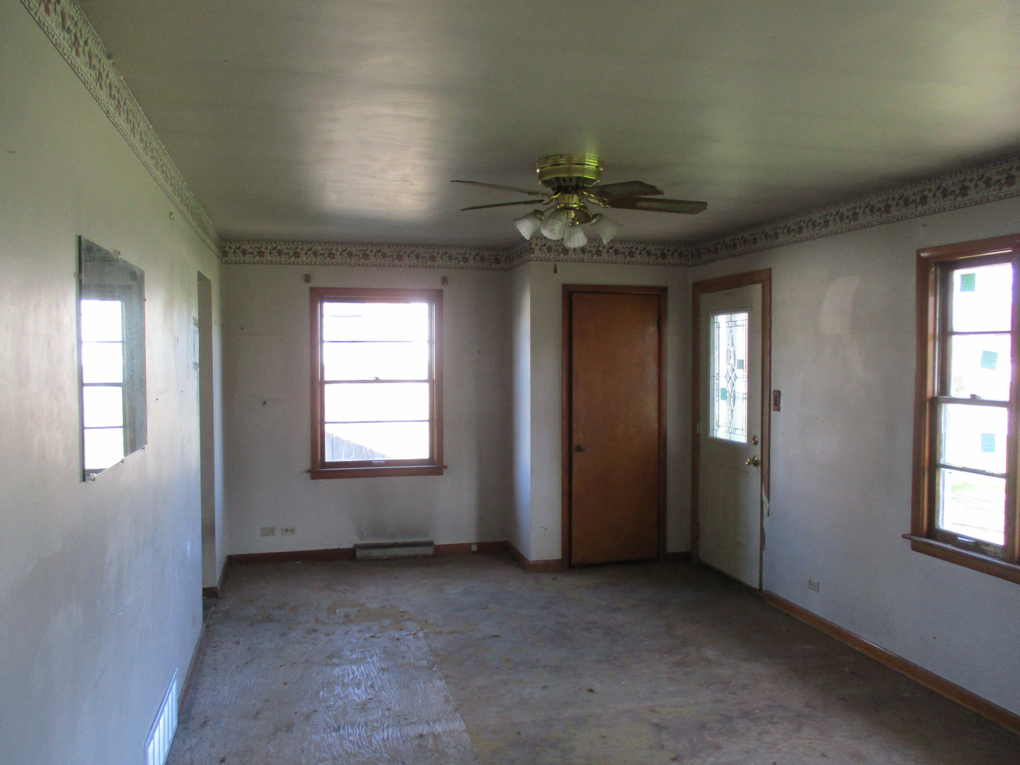 2810 186th Street Lansing, IL 60438 - Photo 5 of 14 an empty room with windows and chandelier fan