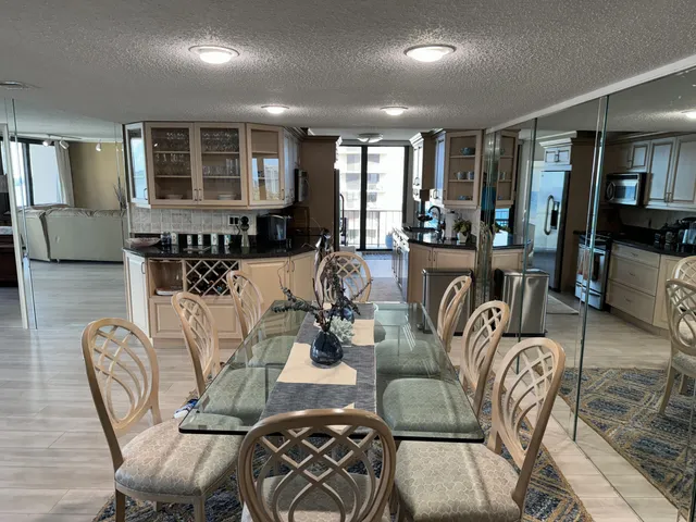 a living room with furniture and a large window with wooden floor