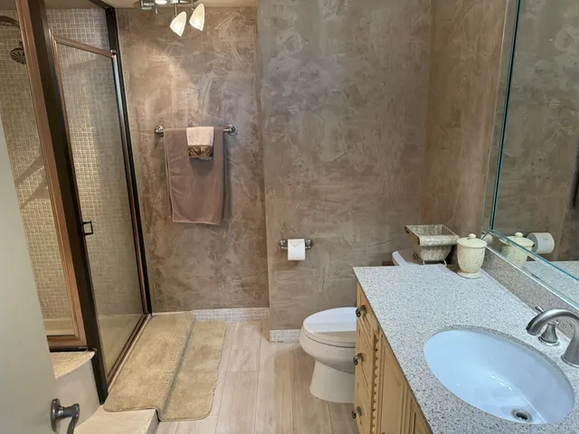 a kitchen with stainless steel appliances granite countertop a refrigerator and a stove