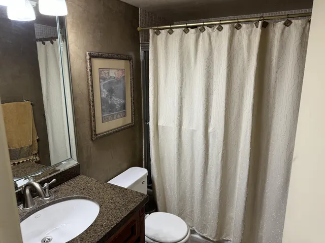 a view of a balcony with chairs and potted plants