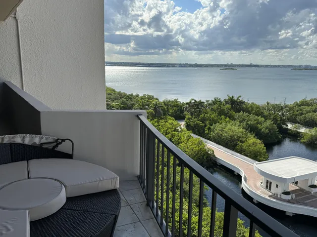 a living room with furniture and large windows